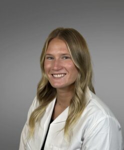 female provider, white jacket, block hair