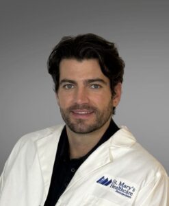 male provider, blue collared shirt, white jacket, brown hair