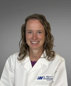 female medical provider, curly hair, white jacket