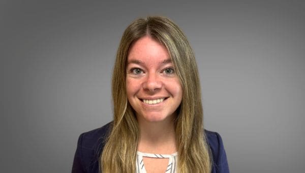 danielle. female, blonde hair, blue jacket, white and blue striped top