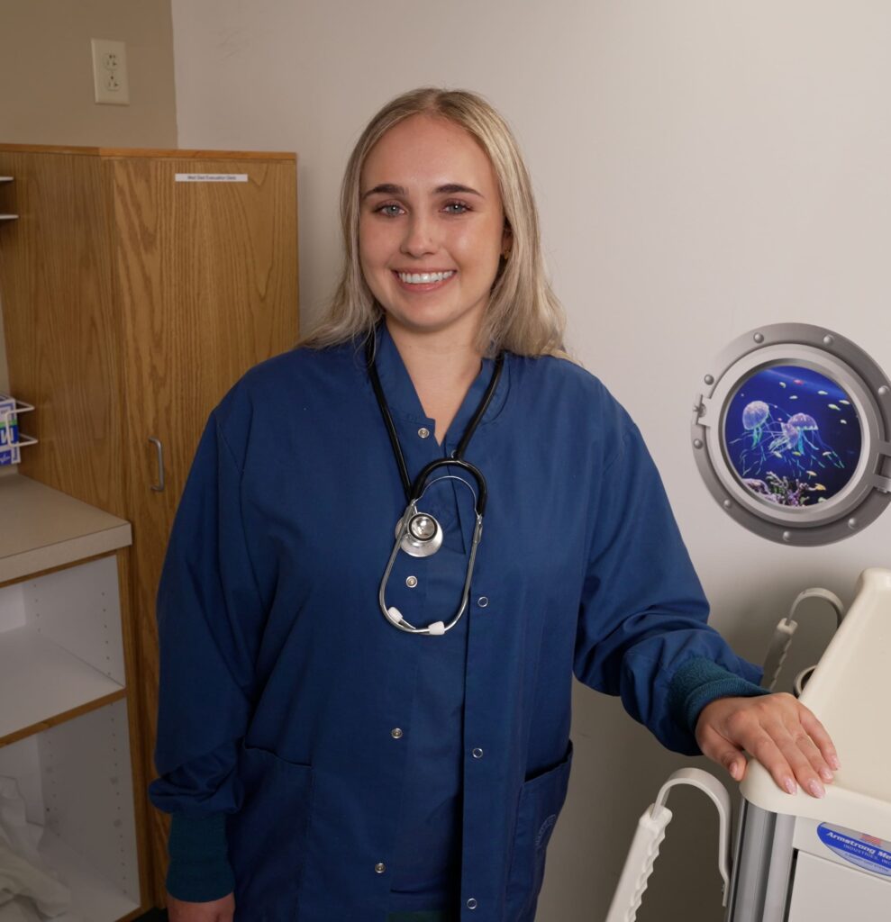 nurse, blue scrubs, stethoscope, blonde hair, in medical patient bay